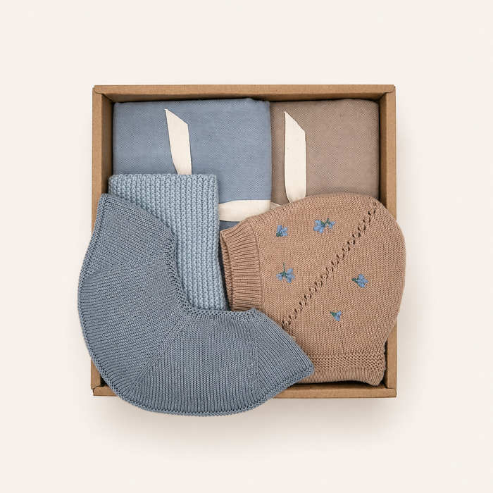 Baby Gift Box with two muslin cloths, knitted baby bib, newborn bonnet and knitted washcloth in soft blue Scandinavian tones by Saga Copenhagen.