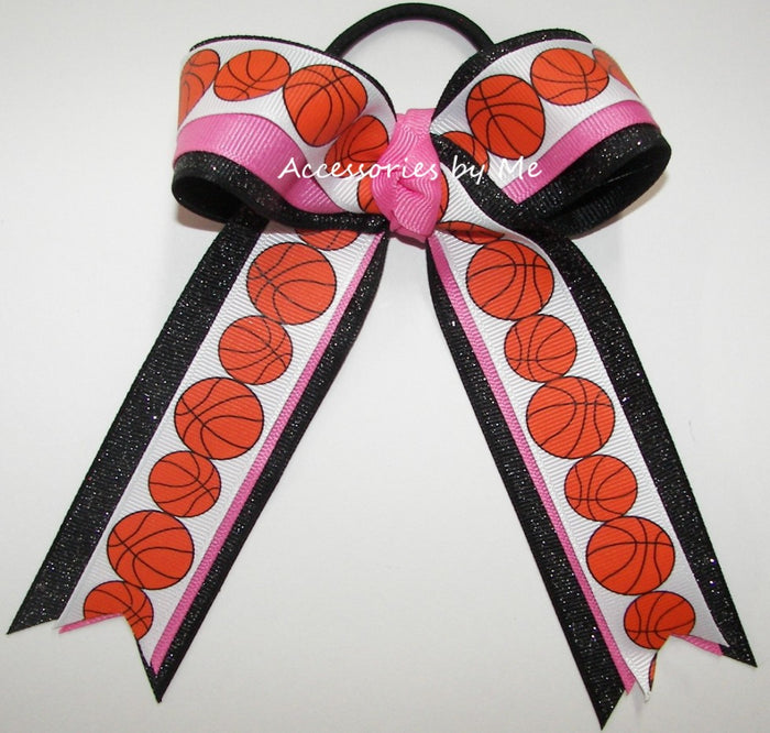 Basketball-themed hair bow with pink and black accents on a white background