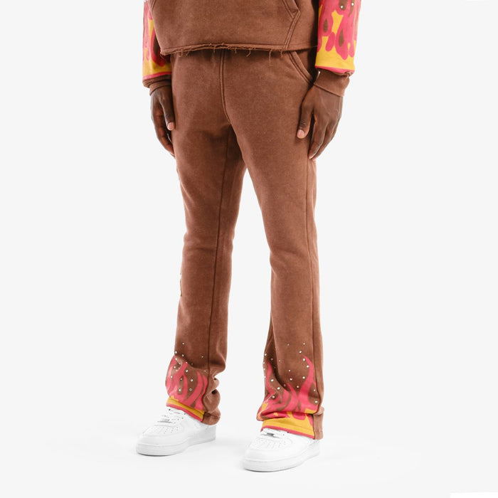Copper Rivet Desires stacked brown sweat pants laid flat, showing the relaxed fit and soft fabric detail.