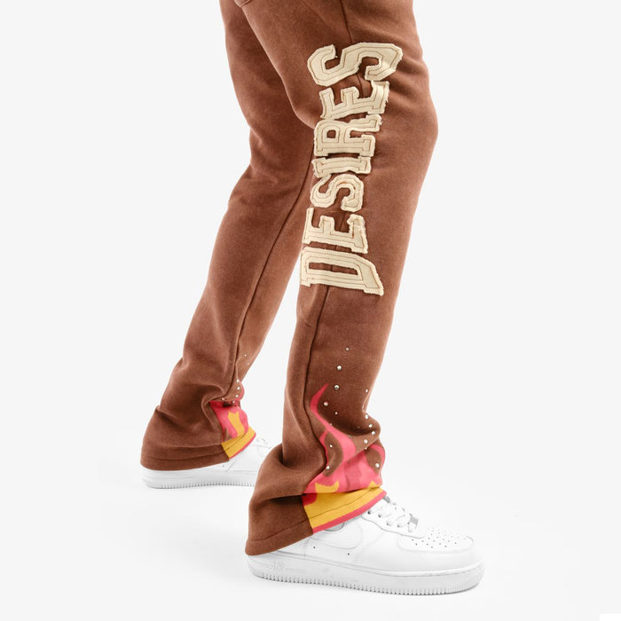 Copper Rivet 'Desires' brown stacked sweat pants with a relaxed fit and elastic waistband, displayed on a model.