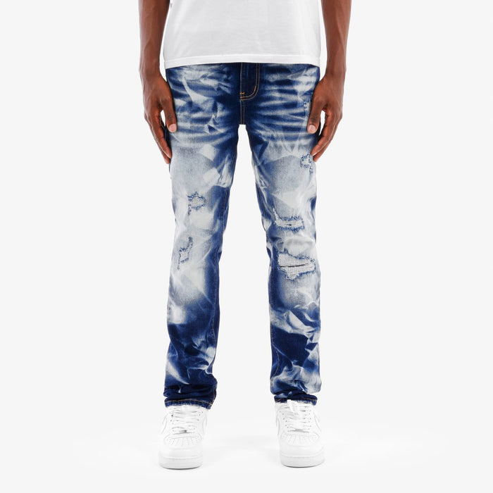 Copper Rivet Rip Heavy Bleach Wash Denim jeans, dark blue denim with distressed details and rivet accents, front view.