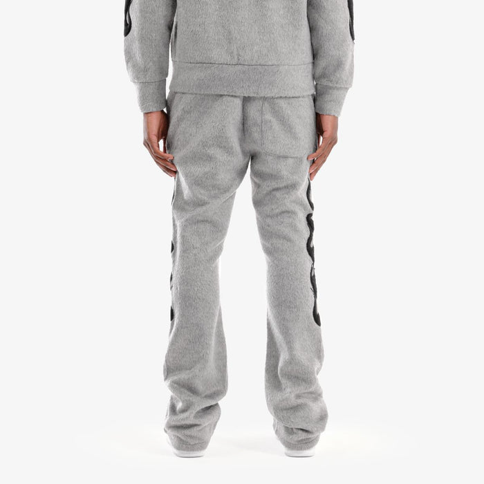 Copper Rivet Saints gray mohair pearl stacked sweat pants with relaxed fit and stylish design, shown on a model.