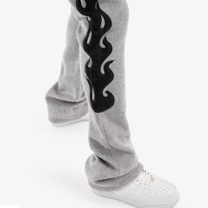 Gray Copper Rivet Saints Mohair Pearl stacked sweat pants with ribbed cuffs and stylish design, shown on a model.