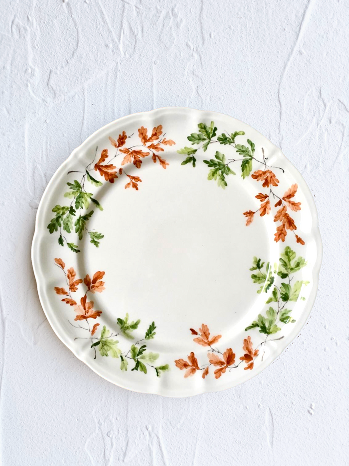 dinner plate with green and orange leaves on rim