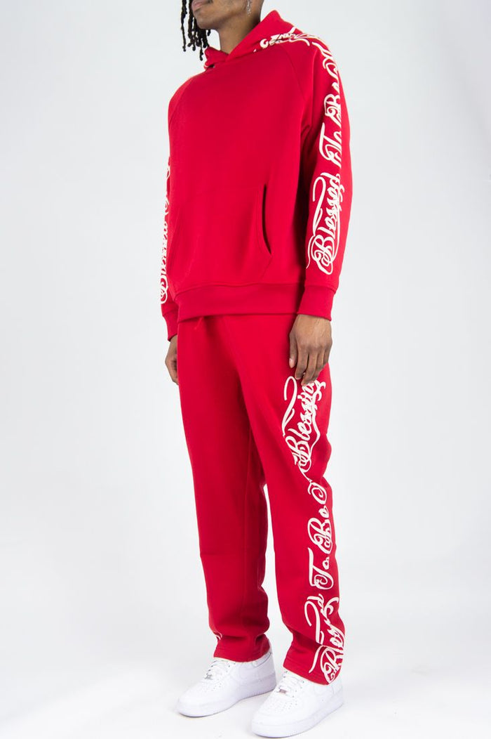 Red Rebel Minds 'Blessed' fleece sweatpants featuring a relaxed fit and branded logo, displayed lying flat.