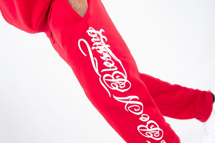 Red Rebel Minds Blessed fleece sweatpants with elastic waistband and relaxed fit, featuring printed design on front.