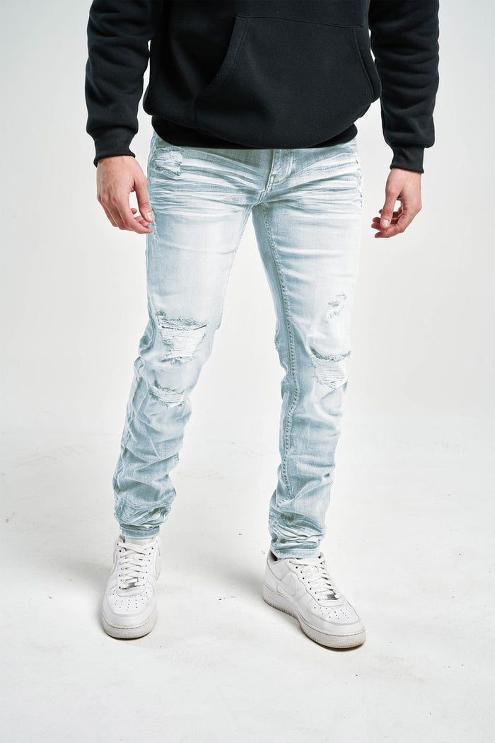 Slim fit stretch denim jeans by Spark, showcasing a close-up of dark blue denim fabric with visible stitching and a classic five-pocket design.