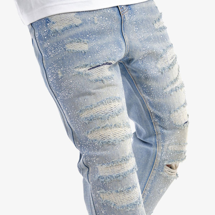 VOYAGE STUDIO Stone On Repair full rhinestone straight fit denim jeans in light blue with distressed details and rhinestone embellishments.
