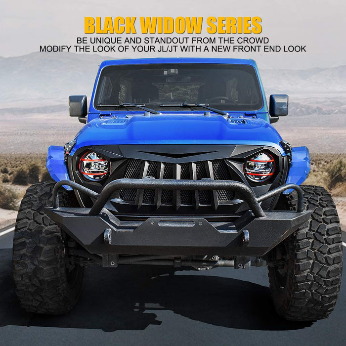 Blue Jeep with black front bumper on a road with desert landscape in the background